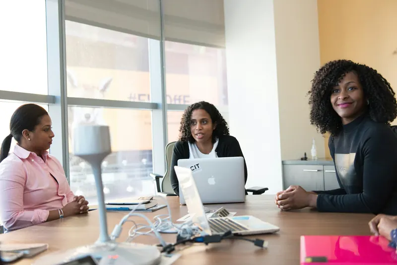 Three colleagues in a meeting at a conference table